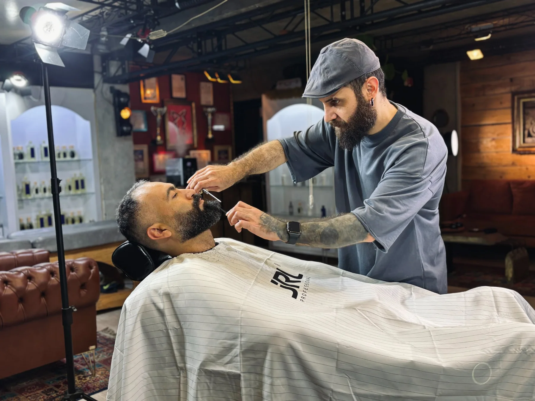 Barber with a client in a warm barbershop setting